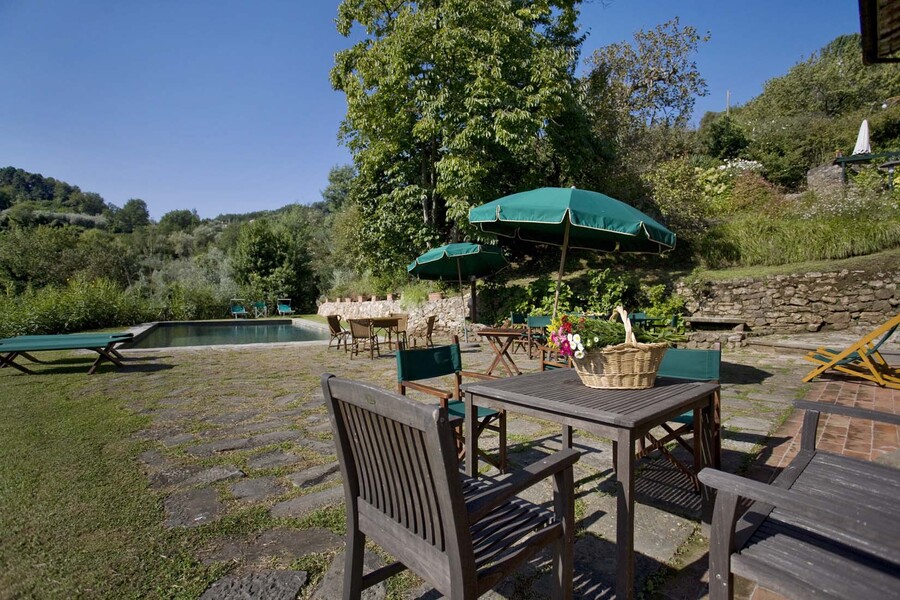 Outdoor table with private pool in the country villa Bottino in Lucca