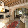 Das Wohnzimmer des Ferienhauses in der Toskana La Capinera besitzt einen großen Kamin, der zu gemütlichen Abenden am offenen Feuer einlädt